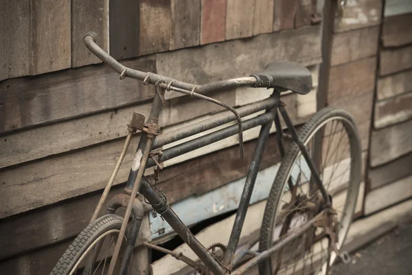 Vintage Bicycle standing near a vintage wood wall