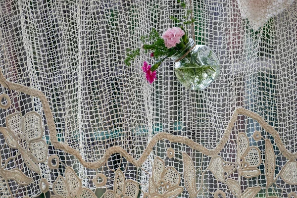 Background with handmade drapery and decorative hanging jar