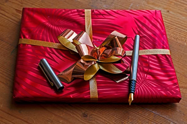 Gift package with open pen on it