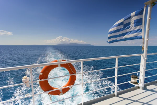 Ferry boat in Greece, view on sea and islands with cruise ship trail