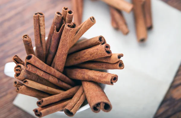 Cinnamon sticks on rustic paper close up with copy space