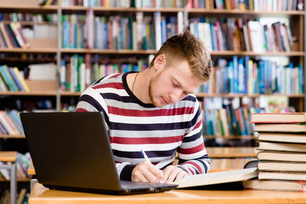 Pensive student with laptop studying