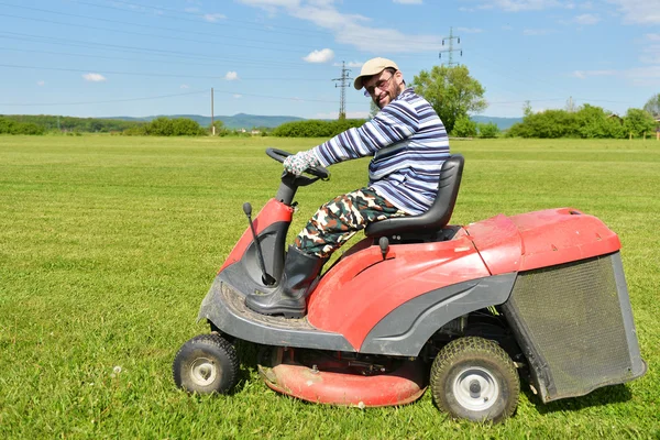 Ride-on lawn mower cutting grass.