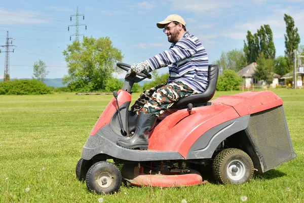 Ride-on lawn mower cutting grass.