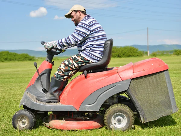 Ride-on lawn mower cutting grass.
