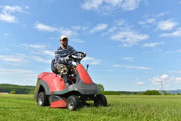 Ride-on lawn mower cutting grass.