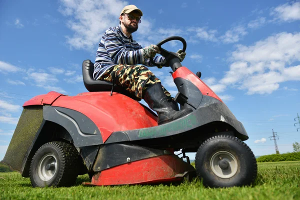 Ride-on lawn mower cutting grass.