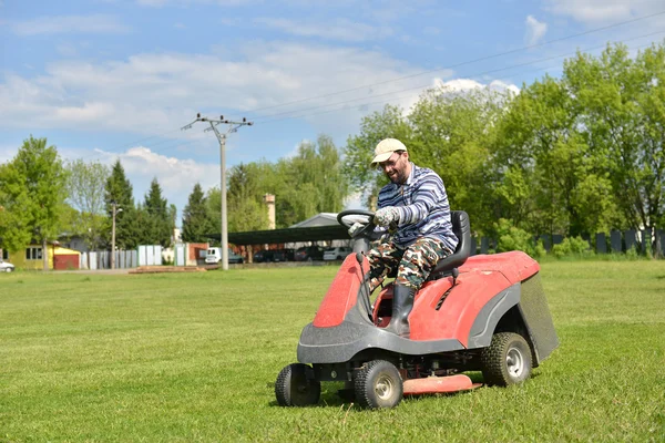 Ride-on lawn mower cutting grass.