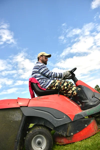 Ride-on lawn mower cutting grass.