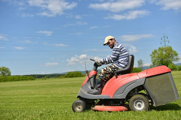 Ride-on lawn mower cutting grass.