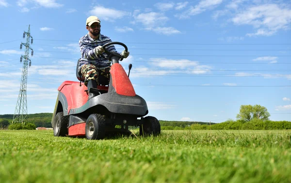 Ride-on lawn mower cutting grass.