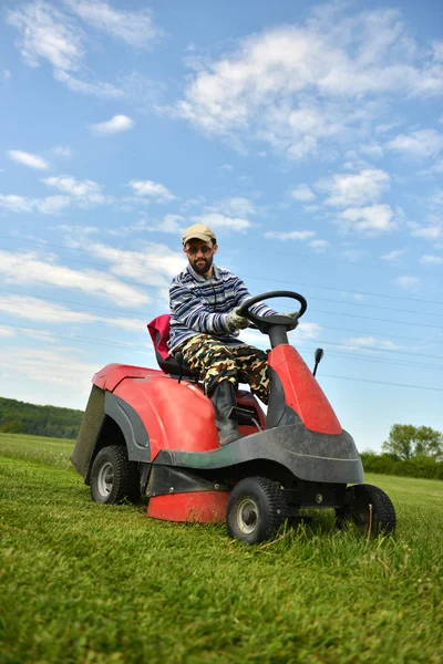 Ride-on lawn mower cutting grass.