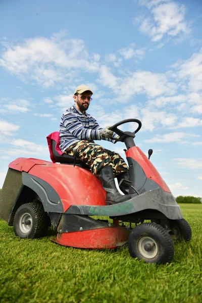 Ride-on lawn mower cutting grass.