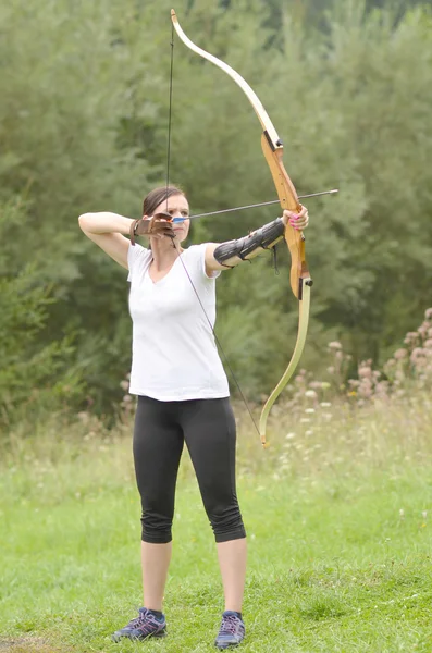 Young woman training with the bow