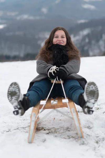 Woman having fun on snow sledge