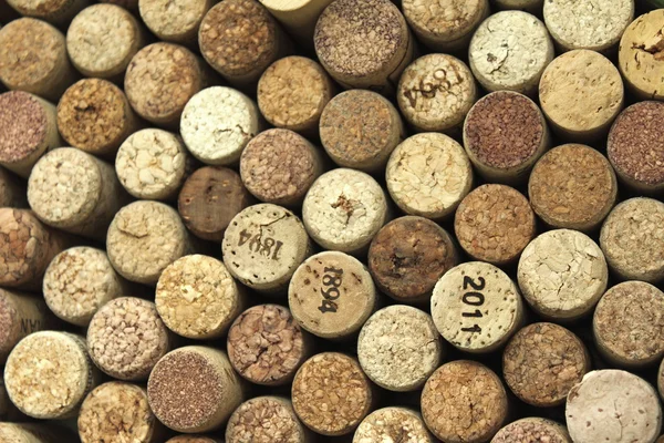 Many different wine corks in the background
