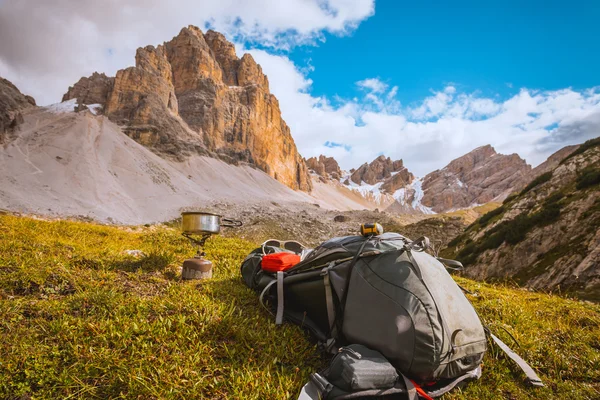 Camping gas and  backpack on Alps background