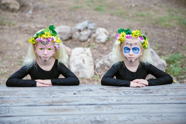 Halloween twin sisters on a table