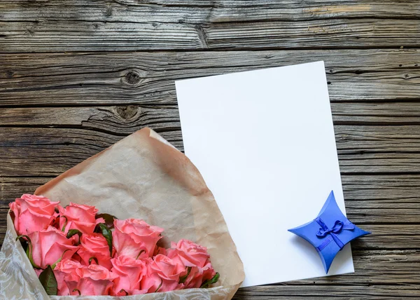 Bag of roses with blank paper and gift box