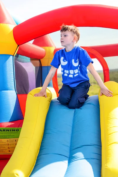 Young boy playing on a bouncy castle