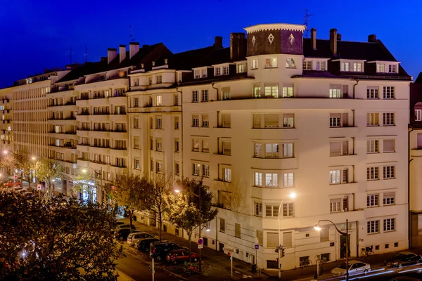 Residential building lit under night sky