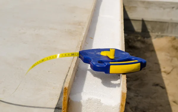 Tape measure on an insulating wall