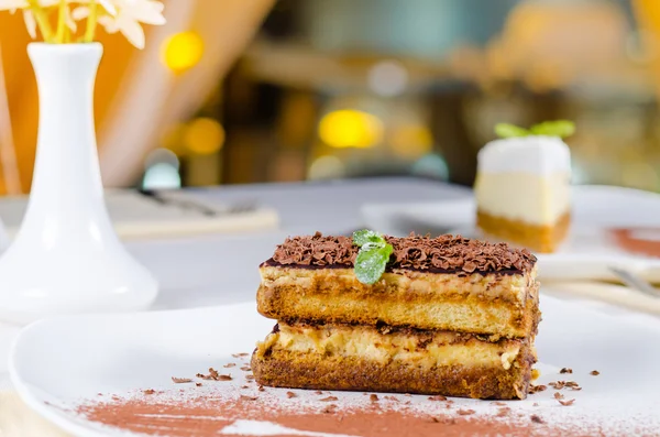 Gourmet Layered Cake on Plate with Cocoa Powder