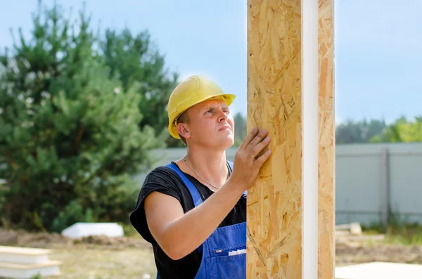 Builder installing wall insulation