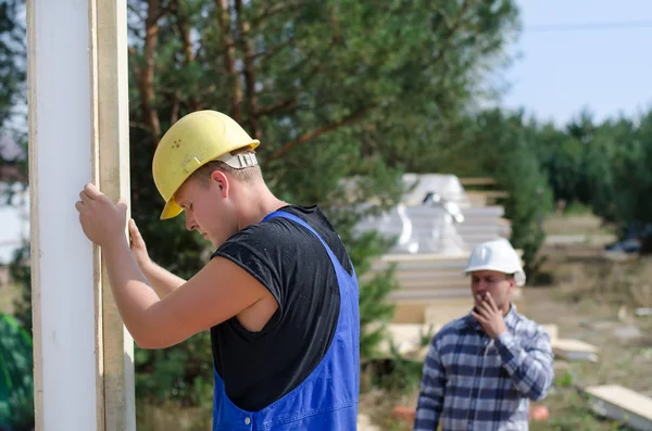 Engineer or foreman watching a builder at work