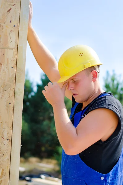 Young builder working on a building site