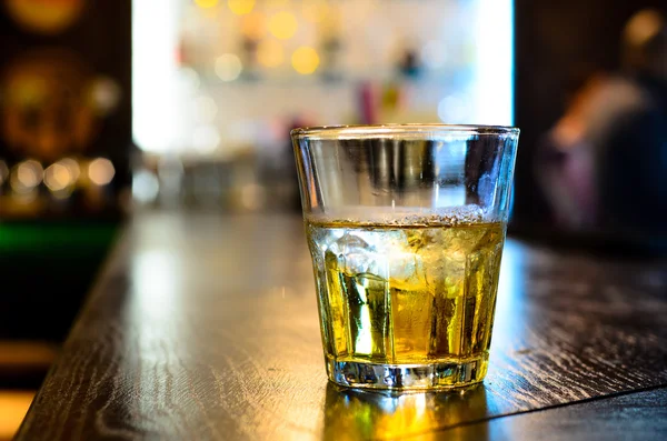 Glass of whiskey on a bar counter