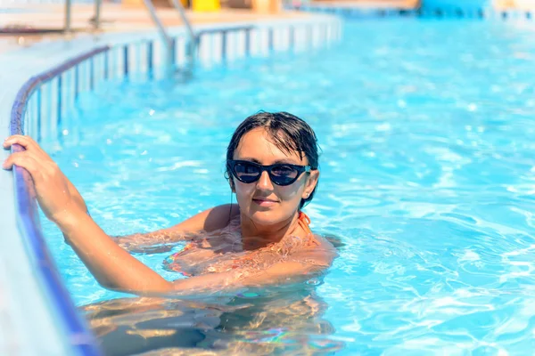 Smiling woman in a swimming pool