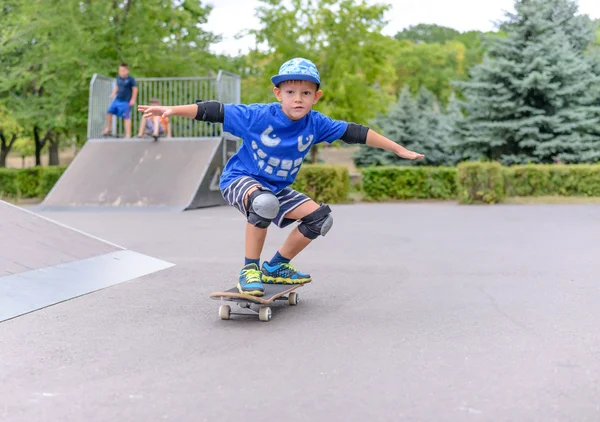 Young boy showing off on his skateboard