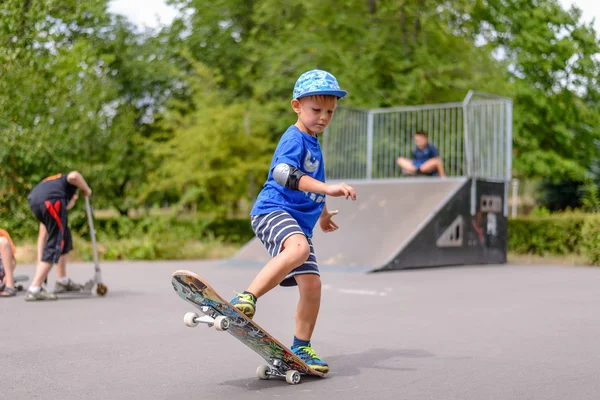 Small boy playing with his skateboard