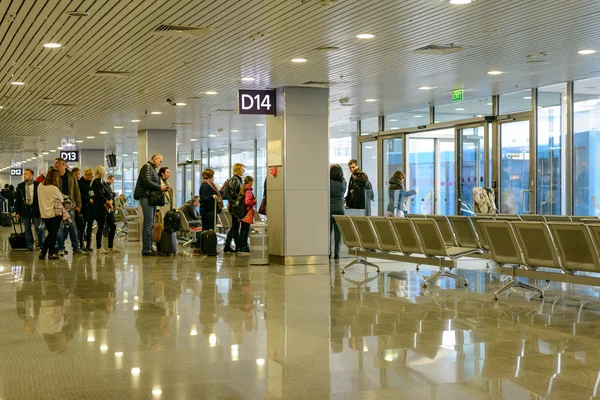 Passengers waiting in a departures hall