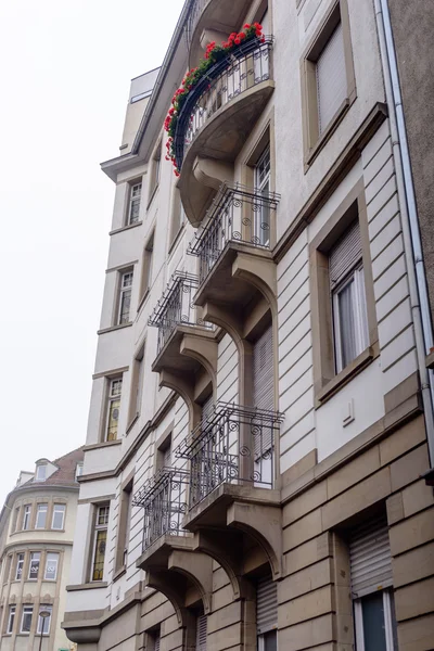 Facade of old European building with balcony autumn