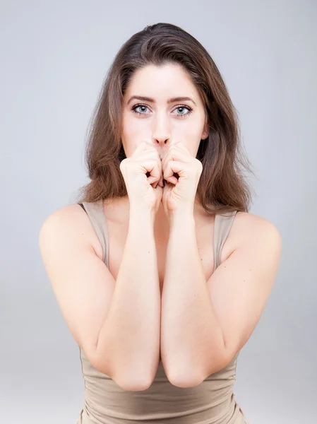 Beautiful young caucasian woman doing face yoga pose