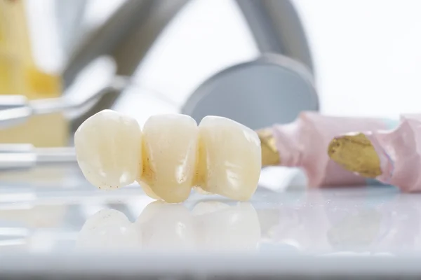 Macro of prosthetic teeth with dental tools