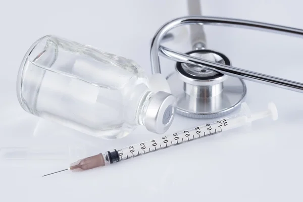 Medical ampoules, syringe and stethoscope