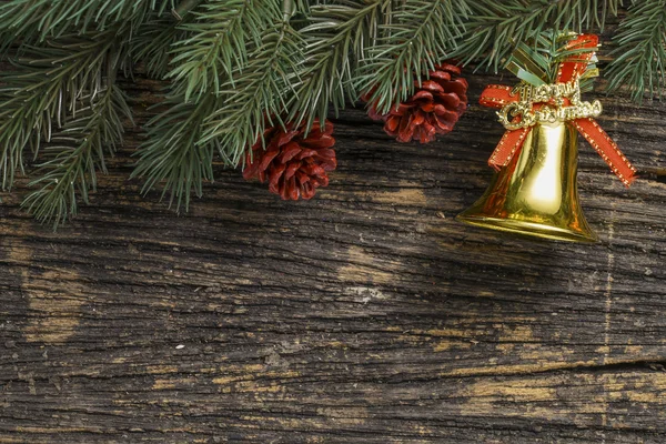 Still life of christmas ornament and tree branch on wooden board