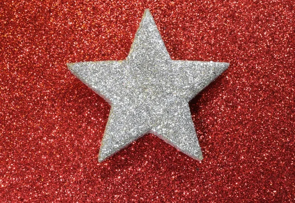 One silver star shining bright red luminescent background