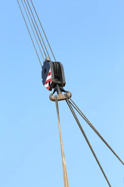 Pulley with sturdy steel cables to lift loads during loading