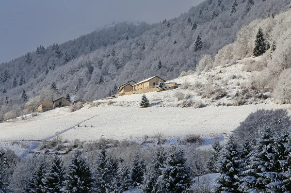 Remote mountain village with the tops of snow-covered mountains