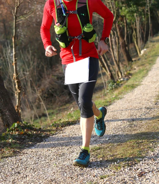 Runner with sports wear during cross-country on a country lane