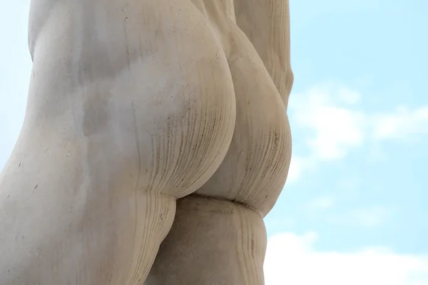 Back of the marble statue with white buttocks