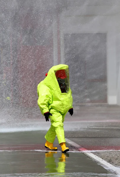 Firefighter with yellow protective gear against biological risk