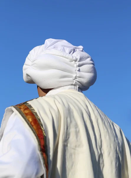 Arab man with turban and blue sky in background