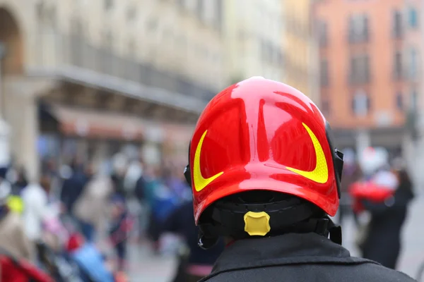 Fireman with red Hardhat controls the people of the city