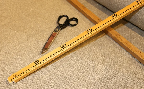 Scissors and the wooden meter in Italian artisan tailoring
