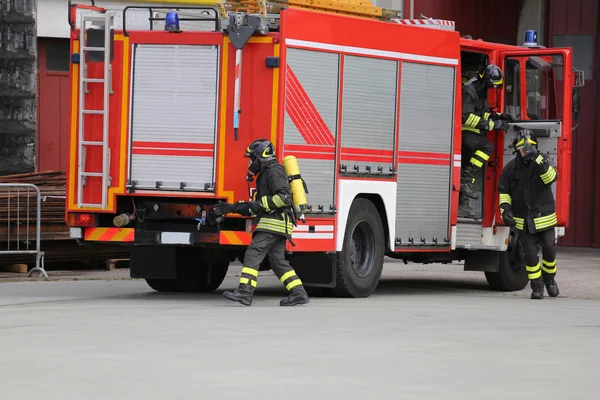 Fire engine with many firefighters  for fighting fire